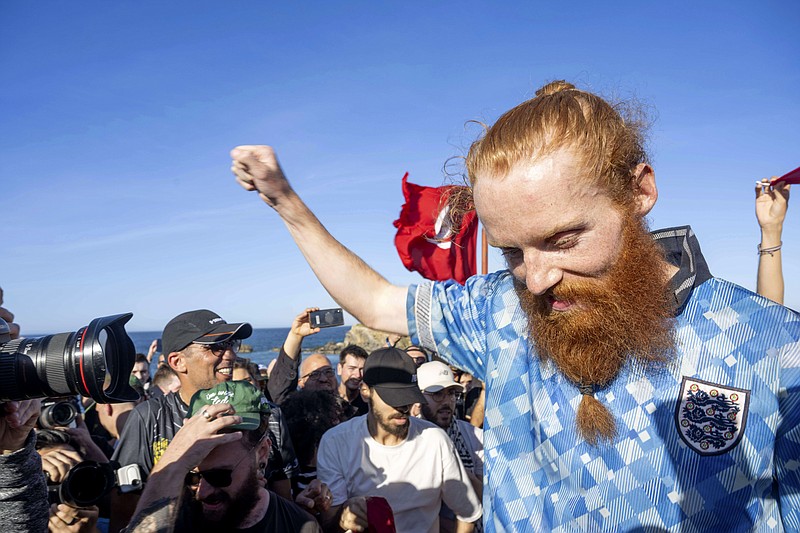 British runner Russ Cook celebrates with supporters after arriving to the finish line in Ras Angela, the most northern point of the African continent, in Tunis, Tunisia, Sunday, April 7, 2024. Cook — known on social media by his nickname, Hardest Geezer — has run more than 16,000 kilometers (10,000 miles), from the south to north of Africa, in 352 days. (The Snapshot People LTD via AP)