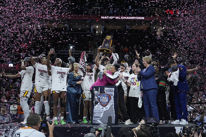 South Carolina players and coaches celebrate after the Final Four college basketball championship game against Iowa in the women's NCAA Tournament, Sunday, April 7, 2024, in Cleveland. South Carolina won 87-75. (AP Photo/Carolyn Kaster)