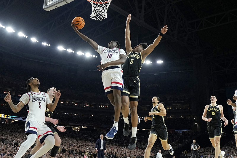 UConn guard Hassan Diarra (10) shoots past Purdue guard Myles Colvin during the second half of the NCAA college Final Four championship basketball game, Monday, April 8, 2024, in Glendale, Ariz. (AP Photo/Brynn Anderson)