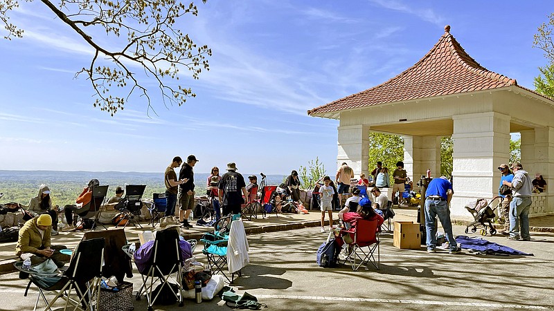 Eclipse watchers start to fill the area around the Hot Springs Mountain Pagoda trail shelter Monday morning in Hot Springs National Park in anticipation of a total eclipse of the sun in the afternoon. (The Sentinel-Record/James Leigh)
