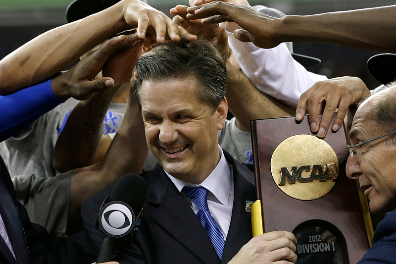 John Calipari, center, celebrates with his Kentucky Wildcats team after the NCAA Final Four tournament college basketball championship game against Kansas Monday, April 2, 2012, in New Orleans. (AP Photo/David J. Phillip)