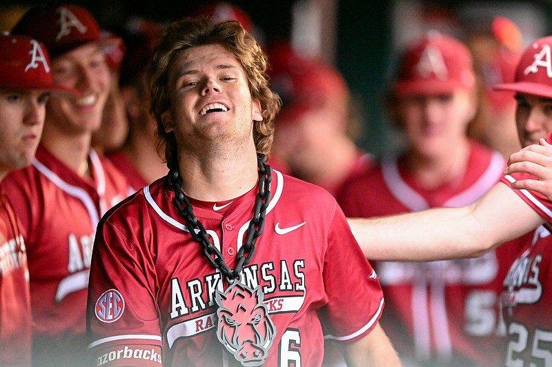 Arkansas' Ben McLaughlin smiles in the dugout after his solo home run in the third inning of a baseball game on Tuesday, April 9, 2024, at Baum-Walker Stadium in Fayetteville. The Arkansas Razorbacks hosted the San Jose State Spartans in a non-conference matchup. Visit nwaonline.com/photo for today's photo gallery. (NWA Democrat Gazette/Caleb Grieger).