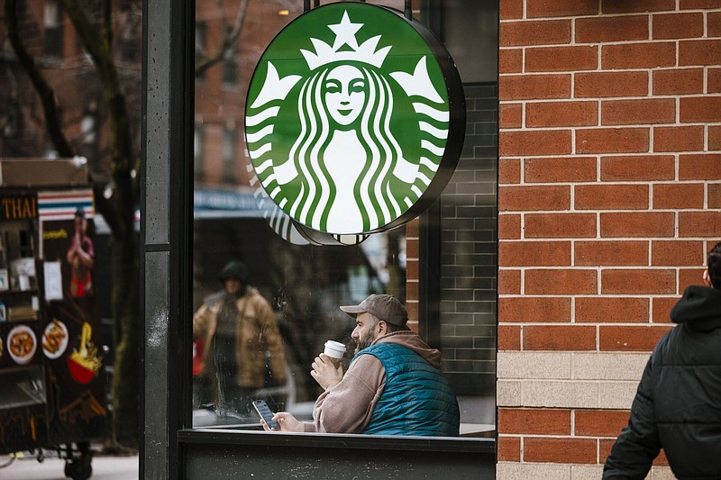 A customer sits in a Starbucks coffee shop in New York.
(Bloomberg News WPNS/Angus Mordant)
