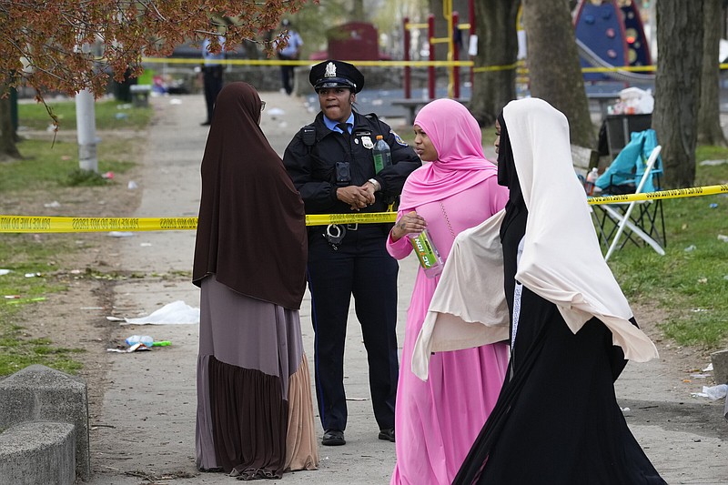 A person talks to an officer in the aftermath of a shooting at an Eid al-Fitr event in Philadelphia on Wednesday.
(AP/Matt Rourke)