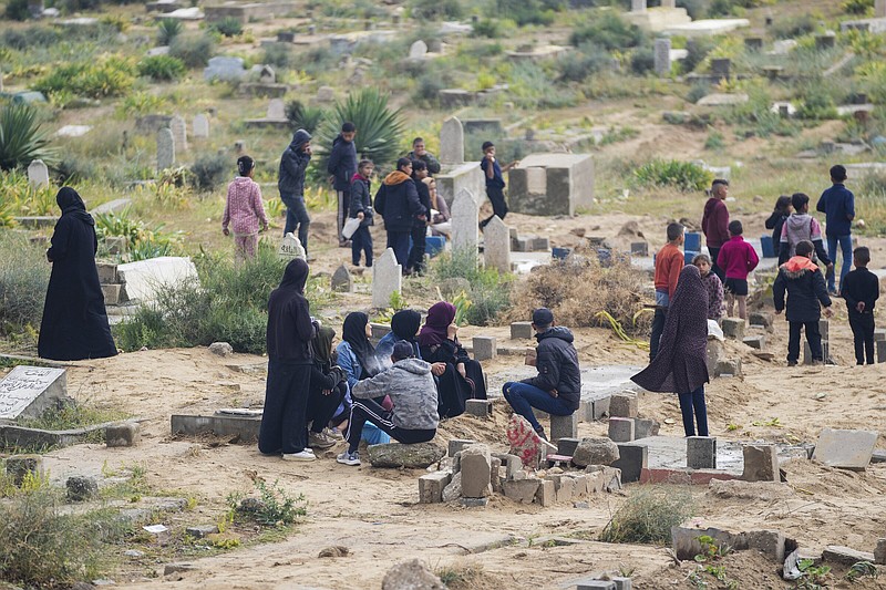 Palestinians visit the graves of their relatives who were killed in the war between Israel and the Hamas militant group on the first day of the Muslim holiday of Eid al-Fitr, in Deir al-Balah, Gaza on Wednesday.
(AP/Abdel Kareem Hana)