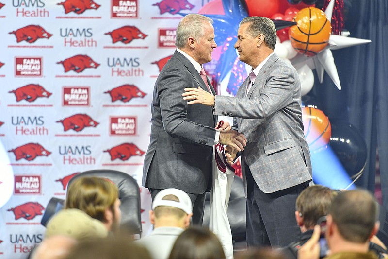 New Arkansas men’s basketball coach John Calipari (right) greets athletic director Hunter Yurachek on stage, Wednesday, April 10, 2024, during an introductory press conference event at Bud Walton Arena in Fayetteville. Visit nwaonline.com/photo for today's photo gallery..(NWA Democrat-Gazette/Hank Layton)