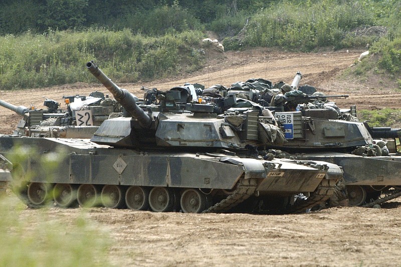 U.S. M1-A1 Abrams tanks block a path at a training range in Paju, near the Demilitarized Zone, about 20 miles north of Seoul in this 2003 file photo. China on Thursday announced sanctions against two U.S. defense companies, one of which produces the M1 tank, over what it says is their support for arms sales to Taiwan.
(AP)