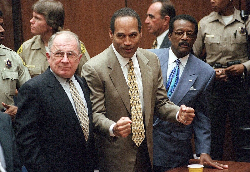 O.J. Simpson reacts as he is found innocent in the death of his ex-wife Nicole Brown Simpson and her friend Ron Goldman in Los Angeles in October 1995, with defense attorneys F. Lee Bailey (left) and Johnnie L. Cochran Jr. standing with him.
(AP/Los Angeles Daily News/Myung J. Chun)