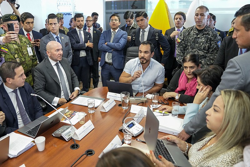 Jonathan Parra (center), president of the oversight commission of Ecuador’s National Assembly, speaks Wednesday as he presides over a meeting where Defense Minister Gian Carlo Loffredo (sitting second from left) and Government Minister Monica Palencia (sitting third from right) explain the raid on Mexico’s Embassy in Quito, Ecuador.
(AP/Dolores Ochoa)