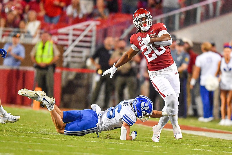 Arkansas running back Dominique Johnson, shown breaking a tackle in last season’s game against BYU at Reynolds Razorback Stadium in Fayetteville, fired up teammates Thursday with a series of big plays in the Razorbacks’ last major practice of the spring before Saturday’s Red-White game.
(NWA Democrat-Gazette/Hank Layton)