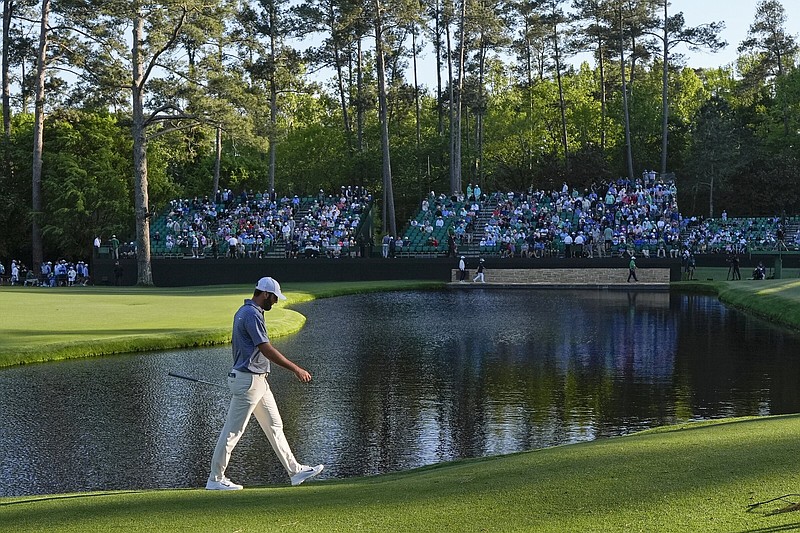 Scottie Scheffler walks to the green on the 15th hole Friday during the second round of the Masters in Augusta, Ga. Scheffler shot an even-par 72 and is in a three-way tie for the lead with Bryson DeChambeau and Max Homa going into today’s third round.
(AP/David J. Phillip)