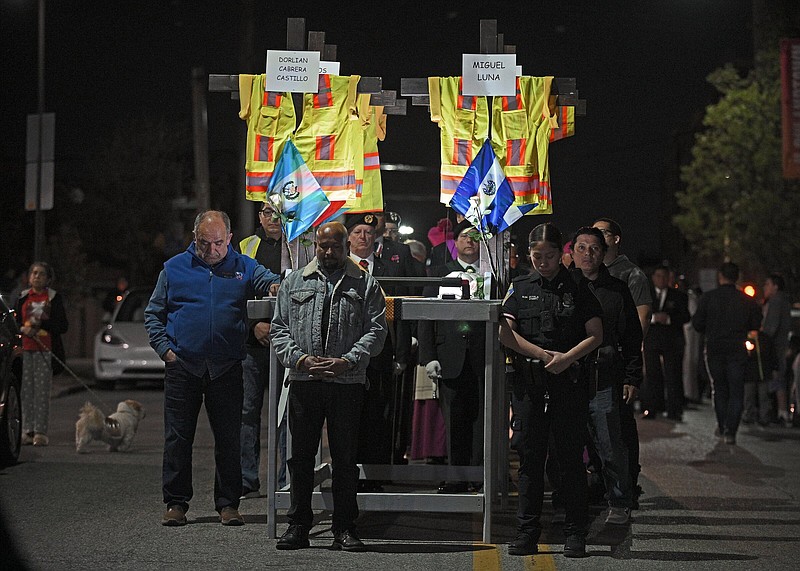 Mourners stand in prayer before carrying the memorial bearing crosses, vests, hardhats and names of the six men who died in the Key Bridge collapse. Hundreds attended a bilingual prayer service held by The Archdiocese of Baltimore at the Sacred Heart of Jesus Christ that was followed by the candlelight prayer walk on Monday.
(Baltimore Sun/TNS/Kenneth K. Lam)