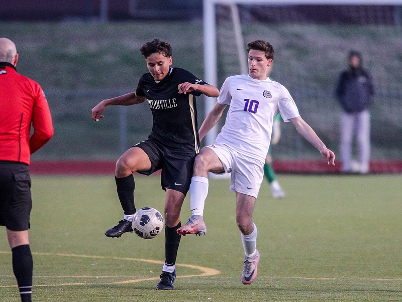Fayetteville Bulldogs Chris Cooper (10) and Bentonville Tigers Sophomore Giovanni Puga (4) fight for control of the ball during the Fayetteville Bulldogs soccer match April 2, 2024. (Special to NWA Democrat-Gazette/Brent Soule)