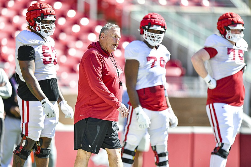 Arkansas head coach Sam Pittman (center) instructs offensive linemen, Saturday, April 6, 2024, during a spring practice at Donald W. Reynolds Razorback Stadium in Fayetteville.(NWA Democrat-Gazette/Hank Layton)