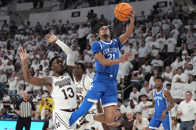 Kentucky guard D.J. Wagner (21) shoots next to Mississippi State guard Josh Hubbard (13) during the second half of an NCAA college basketball game Tuesday, Feb. 27, 2024, in Starkville, Miss. (AP Photo/Rogelio V. Solis)