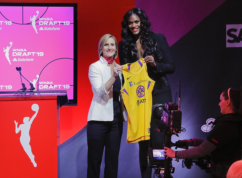 FILE - Baylor's Kalani Brown, right, poses for a photo with WNBA COO Christy Hedgpeth after being selected by the Los Angeles Sparks as the seventh overall pick in the WNBA basketball draft, April 10, 2019, in New York. Everyone likes to look good for a big night on the town. Lots of people will be watching as the WNBA’s next players turn out dressed in their finest looks for Monday night's April 15, 2024, draft. (AP Photo/Julie Jacobson, File)