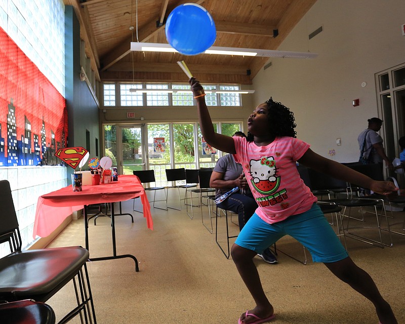 Arianna Williams, then age 8, plays with a balloon after a party celebrating a summer reading program at the Sue Cowan Williams Library in Little Rock in this July 2015 file photo. (Arkansas Democrat-Gazette file photo)