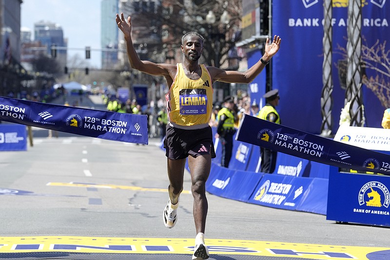 Sisay Lemma, of Ethiopia, breaks the tape to win the Boston Marathon, Monday, April 15, 2024, in Boston. (AP Photo/Steven Senne)