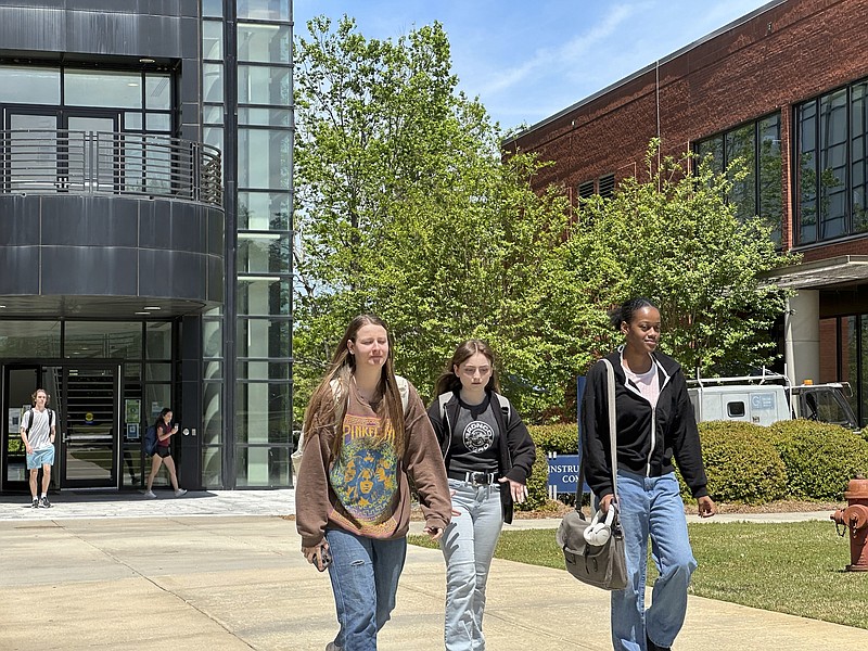 Students walk across the Gordon State College campus on Tuesday, April 16, 2024, in Barnesville, Ga. Regents of the University System of Georgia voted in a meeting at Gordon State to raise tuition and mandatory fees beginning in fall 2024. (AP Photo/Jeff Amy)