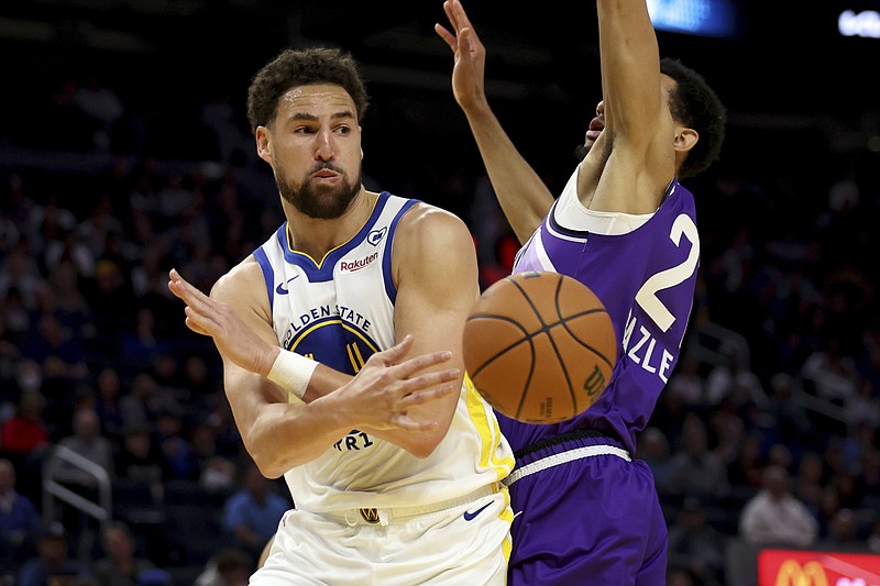 Golden State Warriors guard Klay Thompson (11) passes against Utah Jazz Darius Bazley (21) during the first half of an NBA basketball game in San Francisco, Sunday, April 14, 2024. (AP Photo/Jed Jacobsohn)