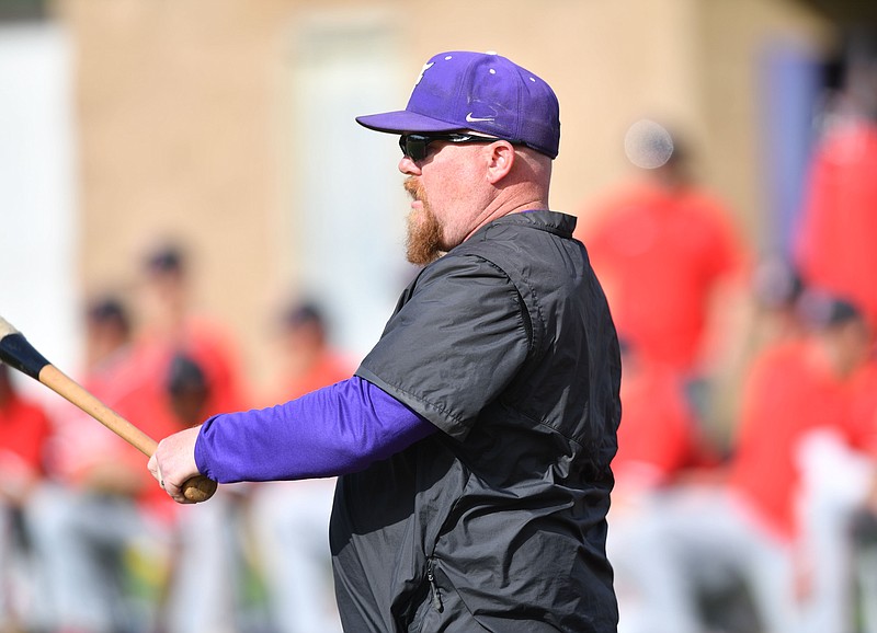 Fayetteville coach Scott Gallagher warms up his infield Monday, March 27, 2023, before the start of the Bulldogs’ 1-0 walk-off win over Fort Smith Northside at Bulldog Field in Fayetteville. Visit nwaonline.com/photo for today's photo gallery. .(NWA Democrat-Gazette/Andy Shupe)