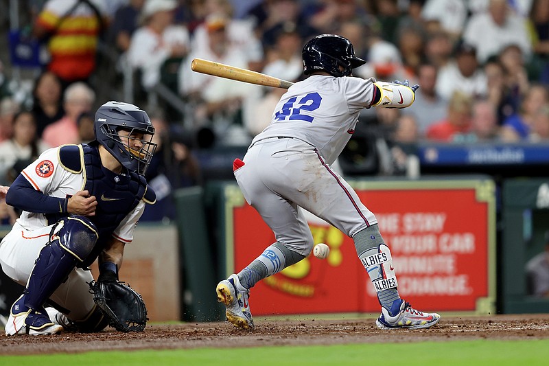 Ozzie Albies of the Atlanta Braves is hit by a pitch with the bases loaded in the second inning against the Houston Astros at Minute Maid Park on April 15, 2024, in Houston, Texas. All players are wearing the number 42 in honor of Jackie Robinson Day. (Tim Warner/Getty Images/TNS)