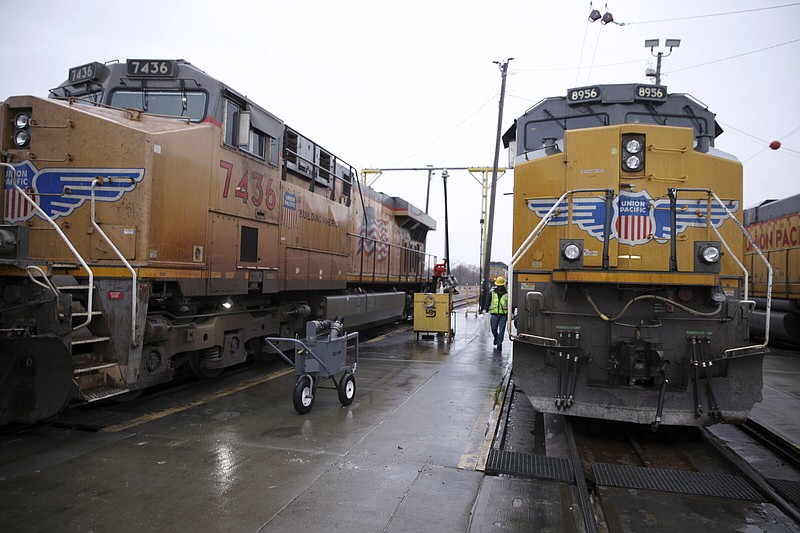A Union Pacific worker walks between two locomotives being serviced in a railyard in Council Bluffs, Iowa, in December.
(AP)