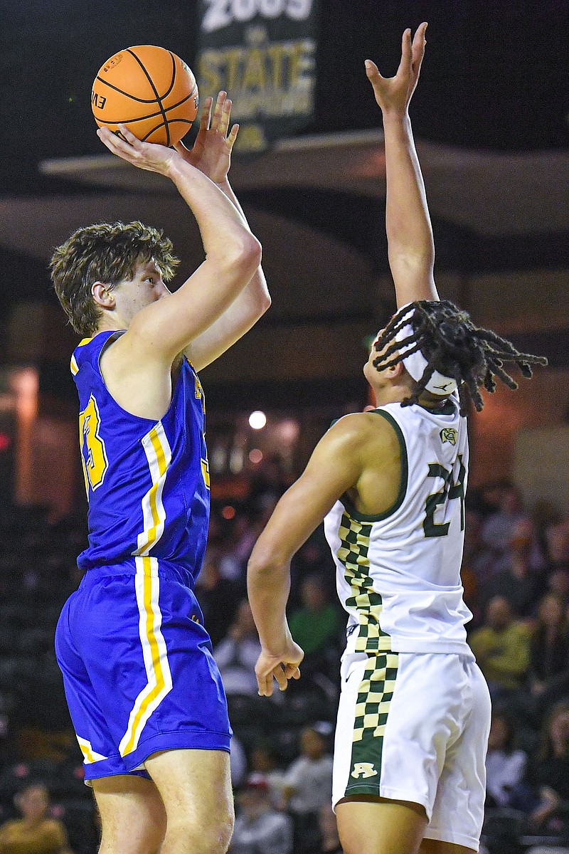 Mountain Home forward Braiden Dewey (33) shoots as Alma center Eddie Tate (24) defends, Friday, Jan. 26, 2024, during the third quarter of the Airedales’ 53-50 win over the Bombers at Charles B. Dyer Arena in Alma. (River Valley Democrat-Gazette/Hank Layton)