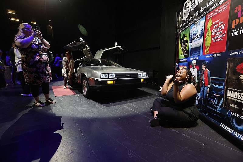 Kamia Evans (right) poses as Christianna Braddix takes her picture after Celebrity Attractions’ 2024-25 Broadway Season Announcement on Wednesday, April 17, 2024, at the Robinson Center in Little Rock. The DeLorean in the background is to promote "Back to the Future: The Musical," which will run March 12-16, 2025. (Arkansas Democrat-Gazette/Thomas Metthe)
