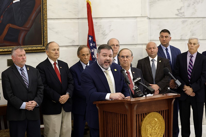 Rep. Matt Duffield (center), R-Russellville, calls on the ATF to release body camera footage from the raid on former Bill and Hillary Clinton National Airport executive director Bryan Malinowski’s home on March 19, during a press conference on Thursday, April 18, 2024, with other members of the Arkansas General Assembly at the state Capitol inn Little Rock. .(Arkansas Democrat-Gazette/Thomas Metthe)