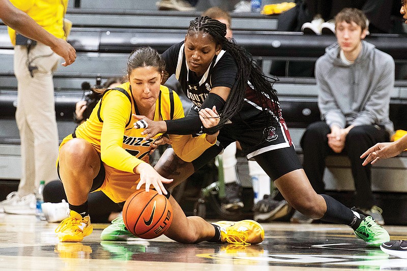 In this Jan. 11 file photo, Sarah Linthacum battles for a loose ball with Sania Feagin during Missouri’s game with South Carolina at Mizzou Arena in Columbia. (Associated Press)