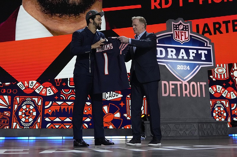 Quarterback Caleb Williams (left) receives congratulations from NFL Commissioner Roger Goodell after being taken by the Chicago Bears with the first selection of the NFL Draft on Thursday night.
More photos available at arkansasonline.com/426nfl24/.
(AP/Jeff Roberson)