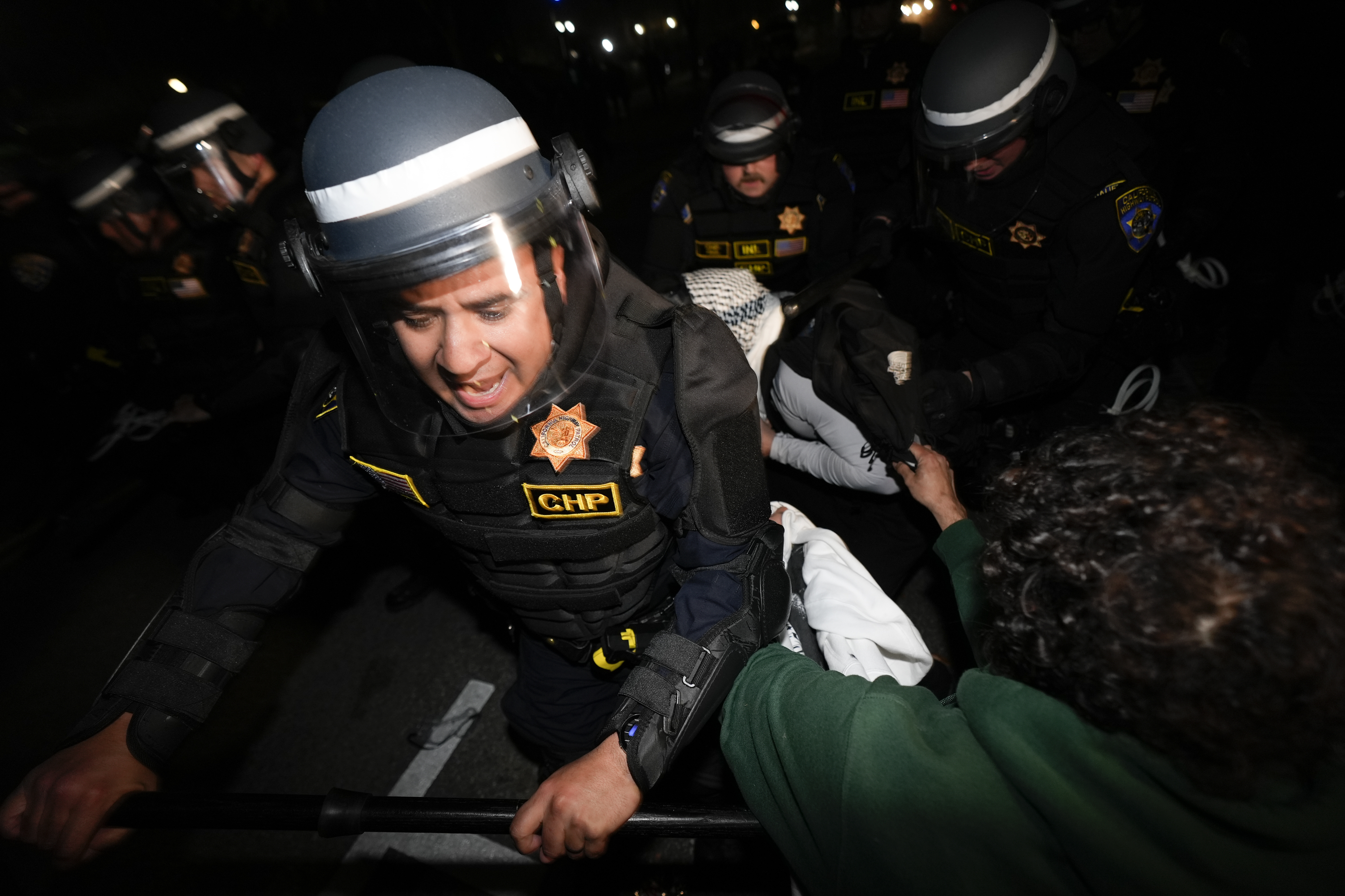 Police advance on demonstrators on the UCLA campus Thursday, May 2, 2024, in Los Angeles. (AP Photo/Ryan Sun)