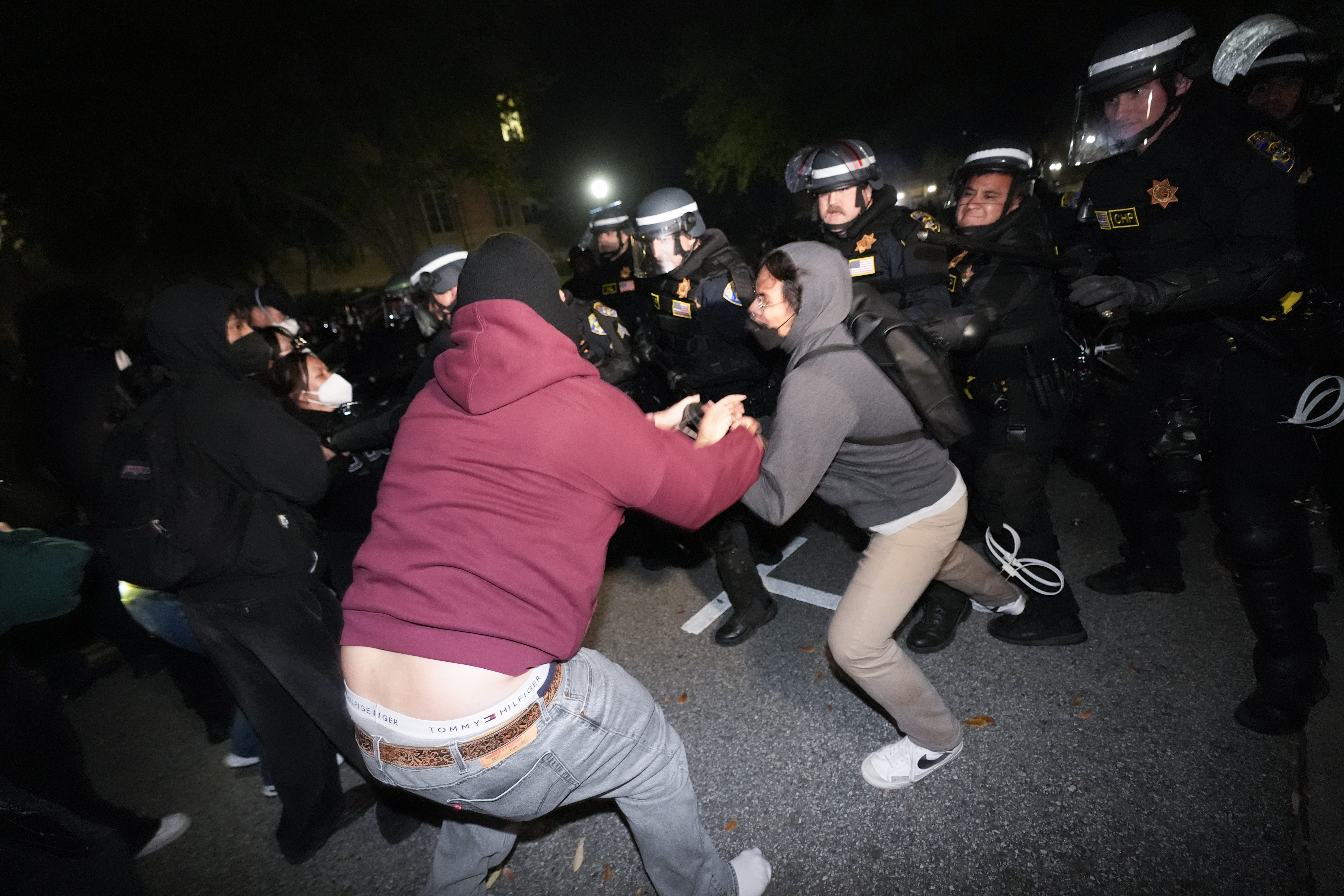 Police advance on demonstrators on the UCLA campus Thursday, May 2, 2024, in Los Angeles. (AP Photo/Ryan Sun)