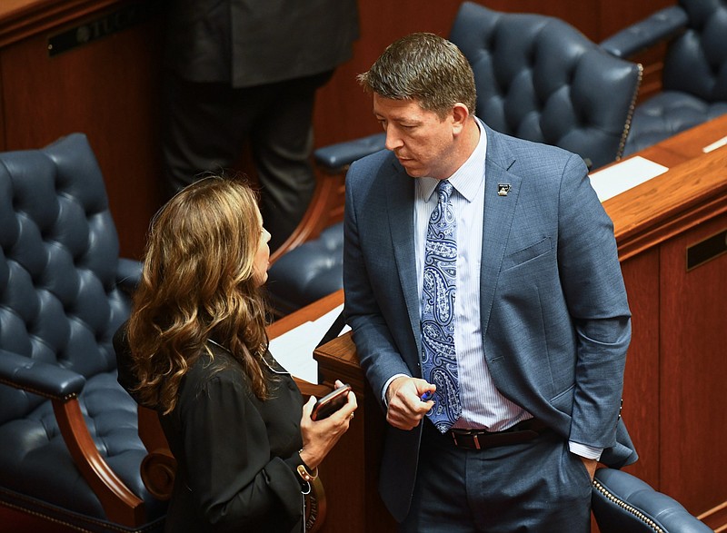 Arkansas state Sen. Missy Irvin (left), R-Mountain View, talks with Sen. Josh Bryant, R-Rogers, on the floor of the Arkansas Senate before the start of a Senate floor session at the state Capitol in this April 24, 2024 file photo. The two sponsored bills on the regulation of crypto mining in Arkansas. (Arkansas Democrat-Gazette/Stephen Swofford)