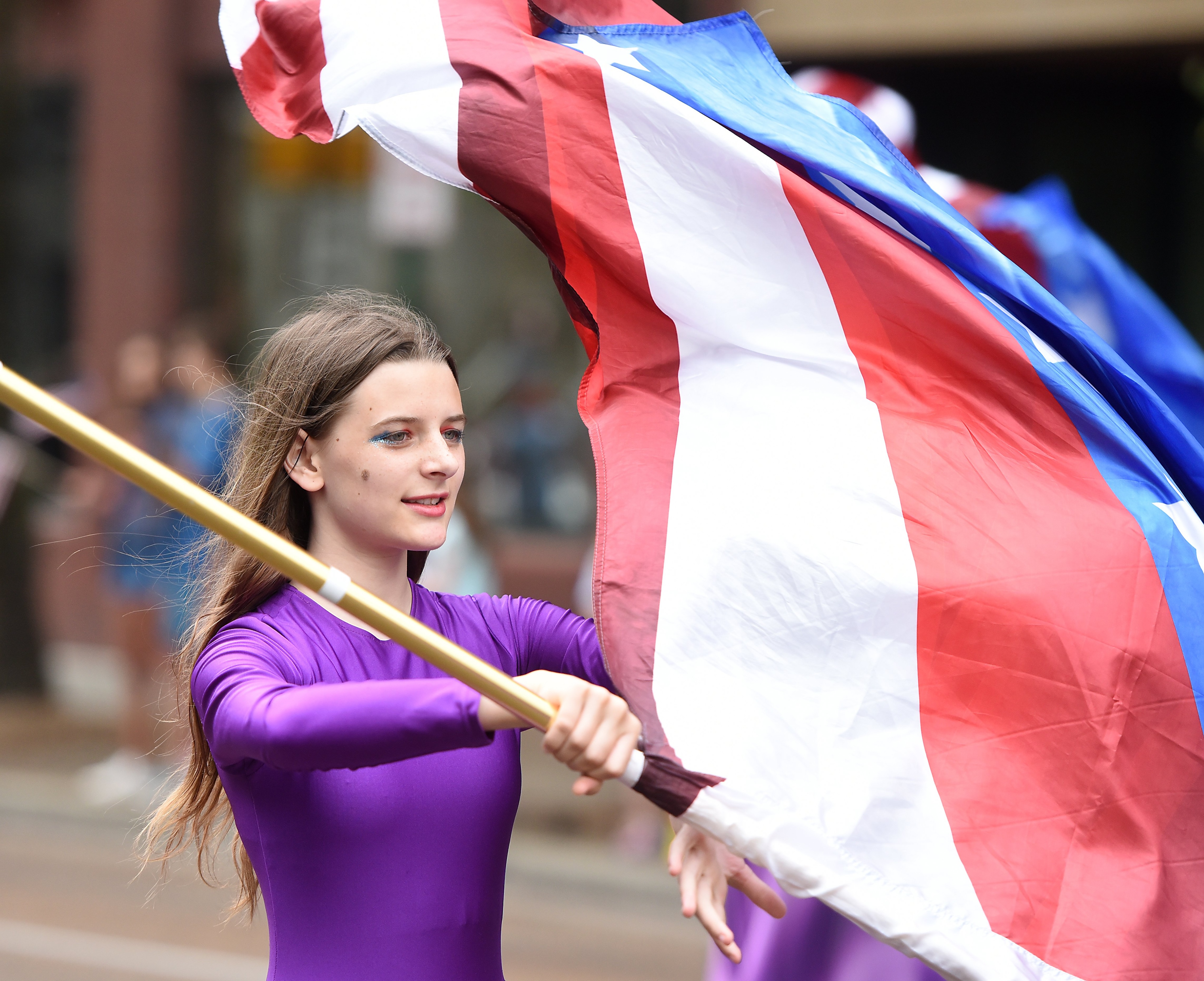 Staff photo by Matt Hamilton/ Sequatchee County High School marching band color guard member Meadow Norberg, 14, twirls a flag on Market Street during the 75th Armed Forces Day Parade on Friday, May 3, 2024.