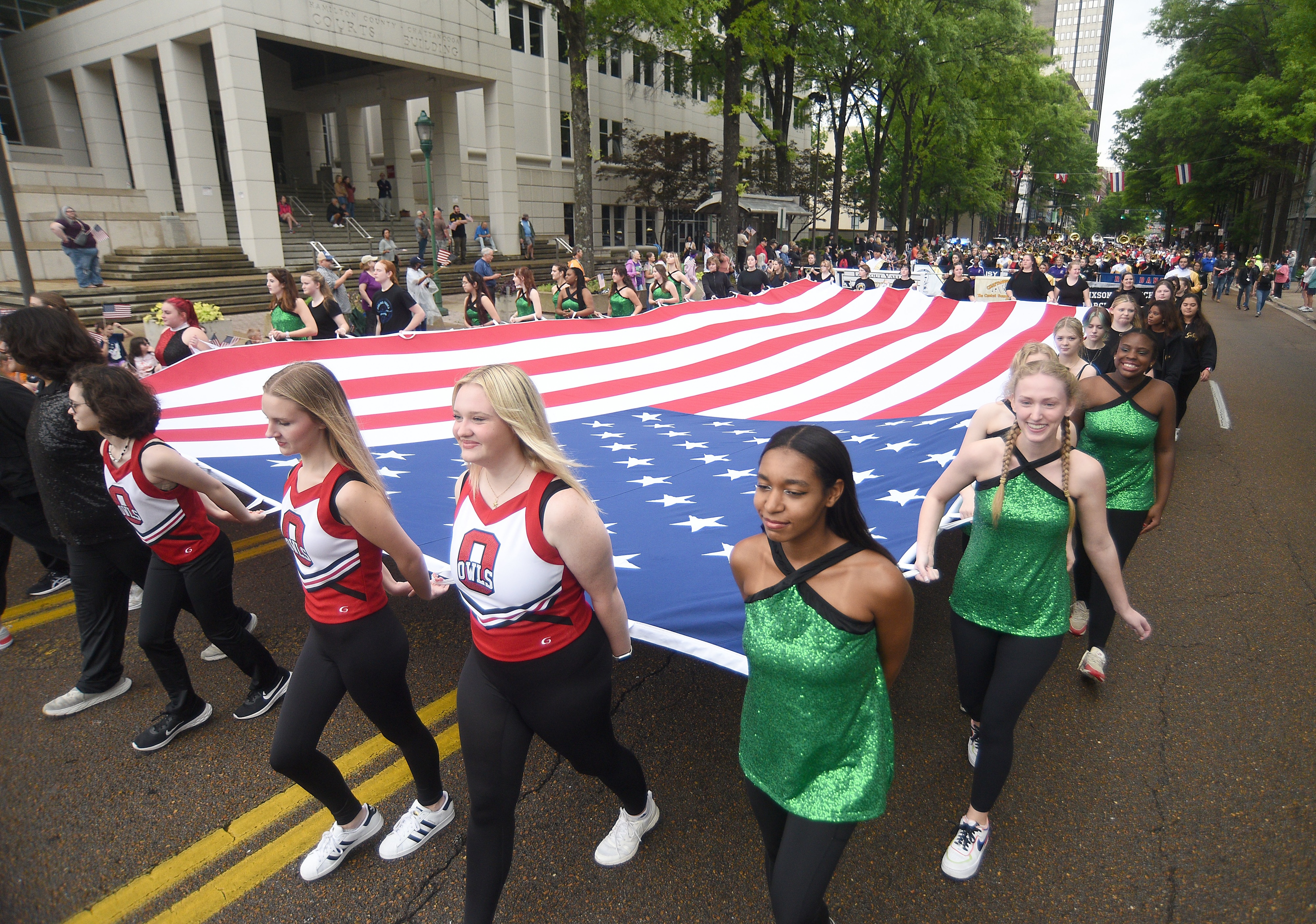 Staff photo by Matt Hamilton/ Members of various high schools carry a large American Flag on Market Street during the 75th Armed Forces Day Parade on Friday, May 3, 2024.