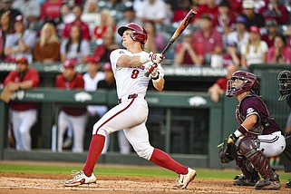 University of Arkansas catcher Hudson White hit a two-run home run in the fourth inning Friday, then broke open a tie game in the eighth inning with a two-run single, giving the No. 3 Razorbacks a 7-5 victory over No. 15 Mississippi State at Baum-Walker Stadium in Fayetteville. More photos at nwaonline.com/511msuua/.
(NWA Democrat-Gazette/Hank Layton)
