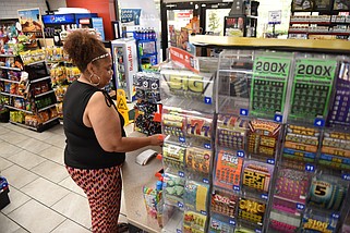 Katrina Wilbon of Little Rock purchases lottery tickets at a Shell gas station in North Little Rock in this Sept. 29, 2023 file photo. (Arkansas Democrat-Gazette/Staci Vandagriff)