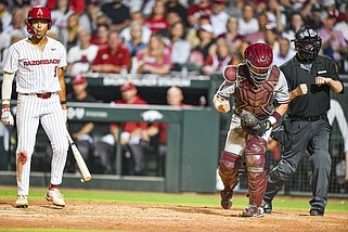Arkansas right fielder Kendall Diggs (left) was called out on strikes by home plate umpire Jeff Head (right) to end the bottom of the eighth inning as Mississippi State catcher Johnny Long celebrates Saturday night at Baum-Walker Stadium in Fayetteville. The third-ranked Razorbacks lost to the No. 15 Bulldogs 8-5. The two teams finish their three-game series at 2 p.m. Sunday. More photos at nwaonline.com/512msuua/
(NWA Democrat-Gazette/Hank Layton)