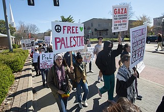 A group of more than 50 people march down Dickson Street in Fayetteville to protest against the war in Gaza in this March 9, 2024 file photo. Friends of Palestine NWA organized the march from the Washington County Courthouse to the University of Arkansas, Fayetteville. (NWA Democrat-Gazette/J.T. Wampler)