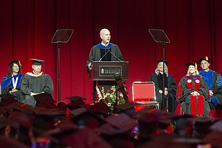 J.K. Symancyk, president and chief executive officer of PetSmart, speaks during commencement ceremonies at the University of Arkansas Sam M. Walton College of Business at Bud Walton Arena in Fayetteville on Saturday, May 11, 2024. Symancyk is a UA graduate. More than 4,400 graduates were honored Saturday in multiple ceremonies. (NWA Democrat-Gazette/J.T. Wampler)