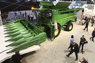 John Deere displays a 20-ton combine harvester aided by artificial intelligence in this Jan. 8, 2019 file photo. The combine has cameras with computer-vision technology to track the quality of grain coming into the machine so that its kernel-separating settings can be adjusted automatically, and farmers can monitor the combine remotely using a smartphone app. The use of artificial intelligence in farming equipment and practices was a key part of the Association of Equipment Manufacturers' second Celebration of Modern Agriculture, held for three days on the National Mall in Washington in May 2024. (AP/Ross D. Franklin)