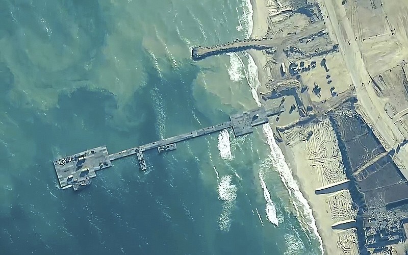 U.S. Army soldiers assigned to the 7th Transportation Brigade (Expeditionary), U.S. Navy sailors assigned to Amphibious Construction Battalion 1, and Israel Defense Forces place the Trident Pier on the coast of Gaza Strip on Thursday.
(AP/U.S. Central Command)