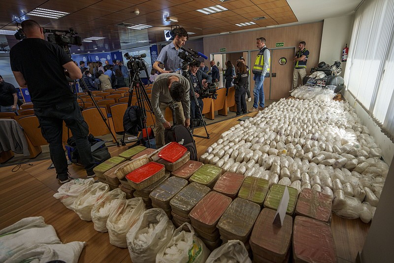 Police officers and journalists stand by part of a haul of 1.8 tons of methamphetamine in Madrid, Spain, on Thursday.
(AP/Manu Fernandez)