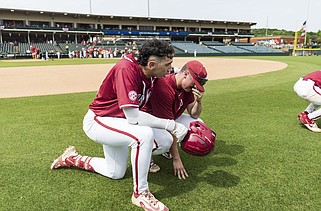 Arkansas third baseman Jared Sprague-Lott (left) consoles teammate Hudson Polk after the Razorbacks’ 6-3 loss to Southeast Missouri State in an elimination game at the NCAA Fayetteville Regional on Sunday afternoon at Baum-Walker Stadium in Fayetteville. The Razorbacks, who were the No. 5 overall national seed entering the NCAA Baseball Tournament, finished the season 44-16. More photos at nwaonline.com/63semoua/
(NWA Democrat-Gazette/Charlie Kaijo)
