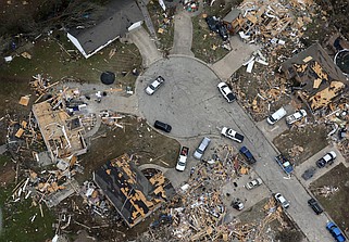 Residents and volunteers clean up a cul-de-sac in Jonesboro in this March 30, 2020 aerial photo. A tornado that hit Northeast Arkansas on March 28, 2020, did varying degrees of damage to the homes in the neighborhood. (Arkansas Democrat-Gazette/Thomas Metthe)
