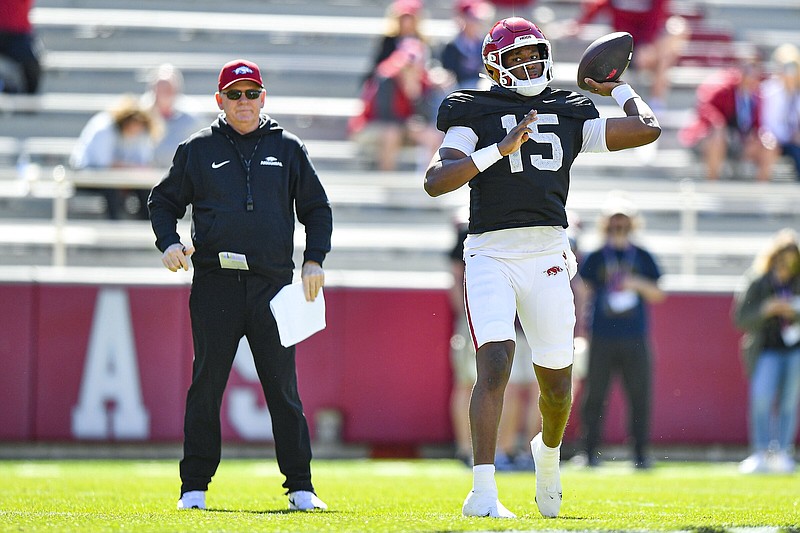 Arkansas offensive coordinator Bobby Petrino (left) looks on as quarterback KJ Jackson (15) passes, Saturday, April 6, 2024, during a spring practice at Donald W. Reynolds Razorback Stadium in Fayetteville. Visit nwaonline.com/photo for today's photo gallery..(NWA Democrat-Gazette/Hank Layton)