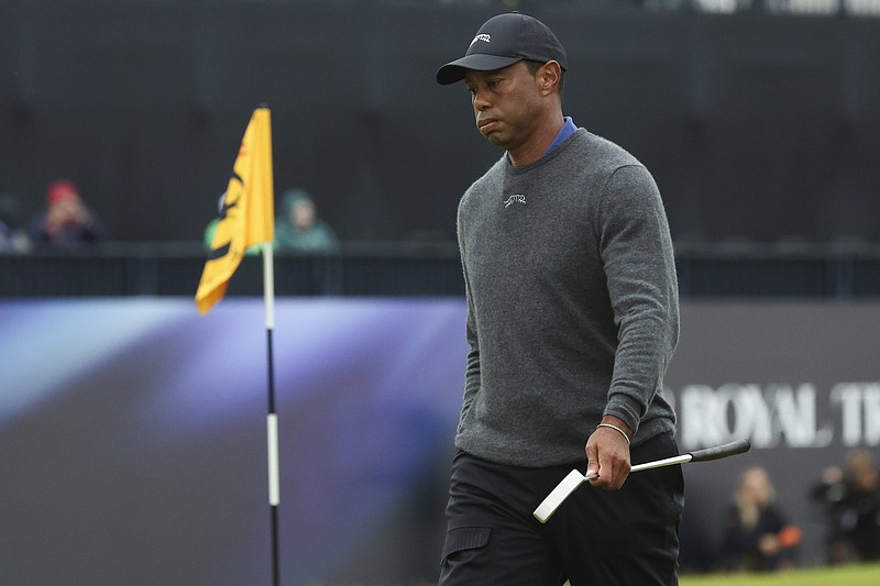 Tiger Woods walks from the 18th green following his opening round of the British Open at Royal Troon Golf Club in Troon, Scotland on Thursday. Woods shot an 8-over 79 and is in serious danger of missing the cut.
(AP/Scott Heppell)