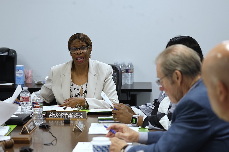 Executive Director Nadine Jarmon (left) talks with board members during the Metropolitan Housing Alliance’s board of commissioners meeting on Thursday, July 18, 2024, in Little Rock. .(Arkansas Democrat-Gazette/Thomas Metthe)